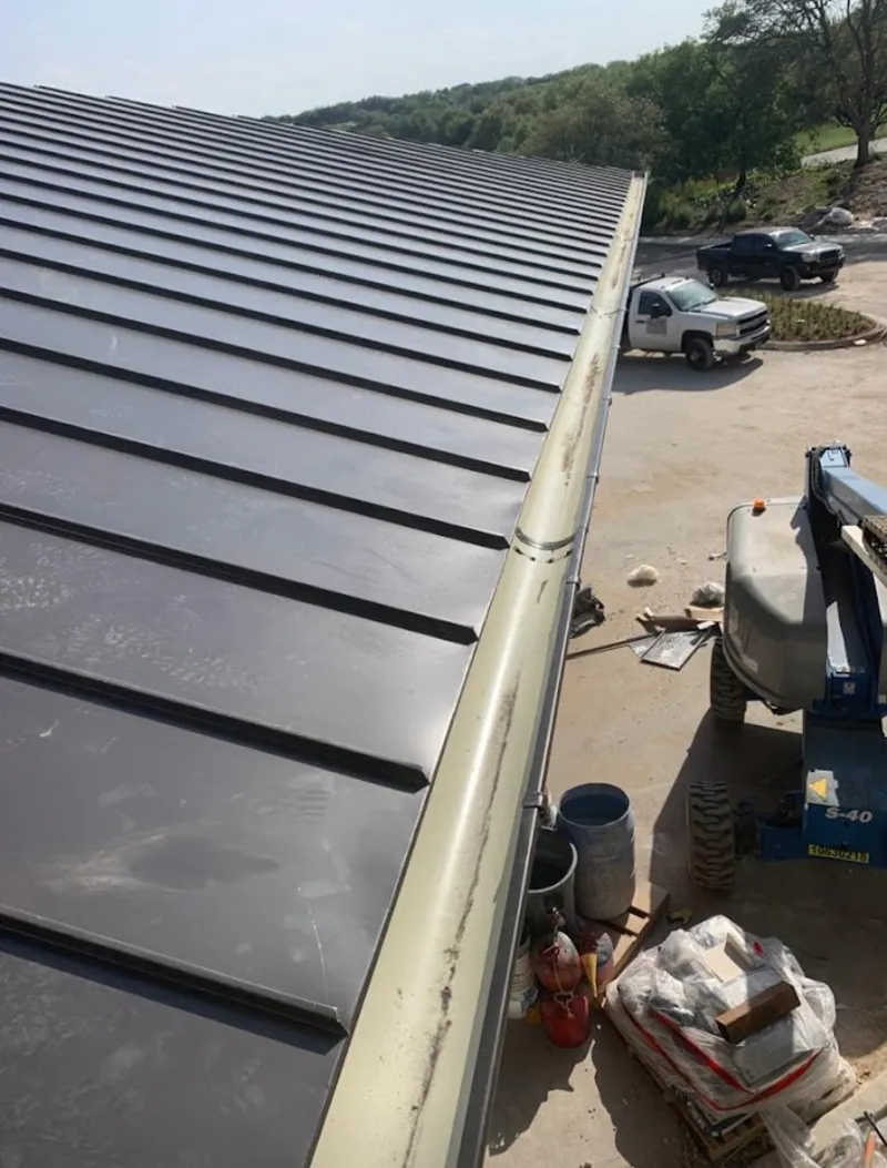 Standing seam panel and gutter detail on a metal roofing jobsite in New Port Richey